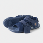 A pair of navy blue sandals with the brand name "Pied Vital" printed on them.